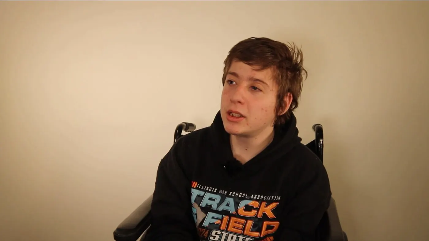 Luke Soukup speaking to the camera in a track and field hoodie
